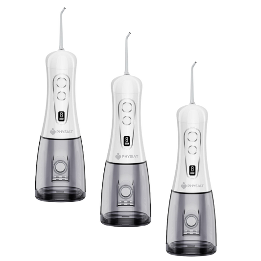 Three white dental water flossers with visible branding on a white background